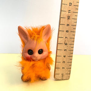 raul happy gang rabbit with orange fur , with ruler to show that he is 9 cm tall 