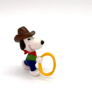 c1980s collectable  PVC vinyl Peanuts figure of Snoopy as a Cowboy with a lasso in his hand .    