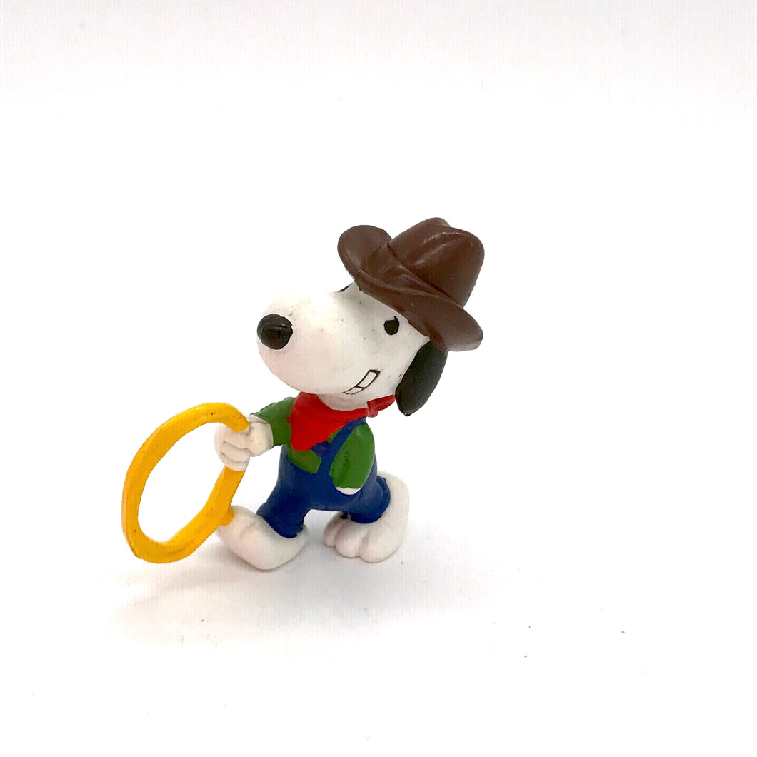 c1980s collectable  PVC vinyl Peanuts figure of Snoopy as a Cowboy with a lasso in his hand .    